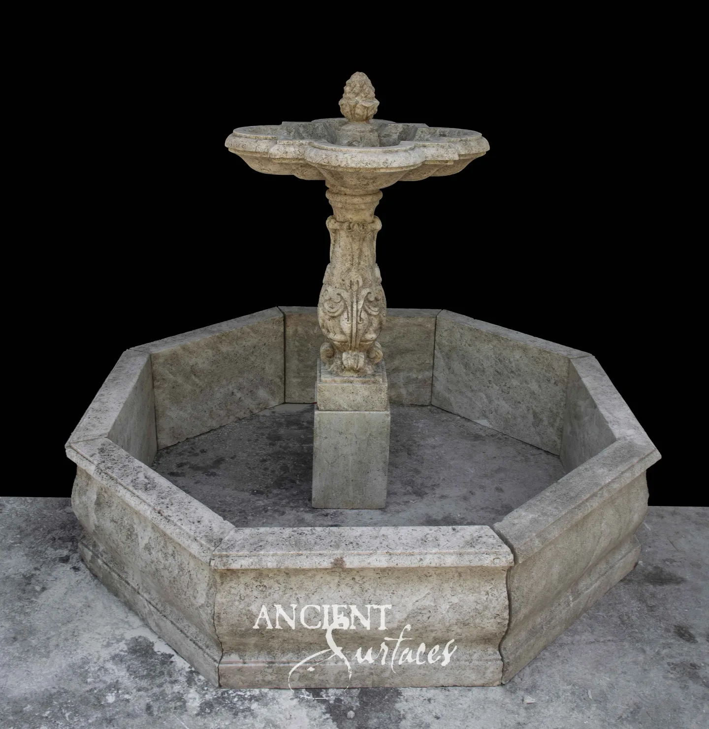 Reclaimed octagonal limestone fountain from Ancient Surfaces with a carved quatrefoil bowl and pinecone finial on an acanthus stem