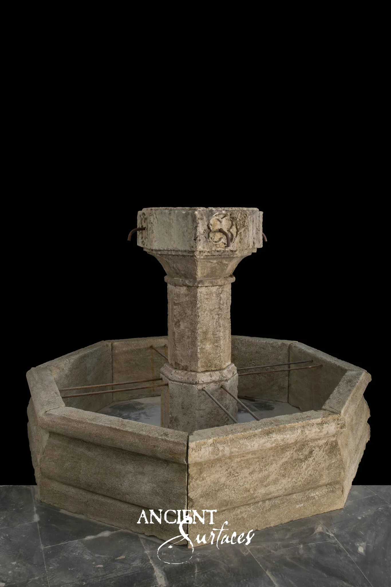 Reclaimed antique limestone fountain from Ancient Surfaces with a raised carved chalice basin on an octagonal column
